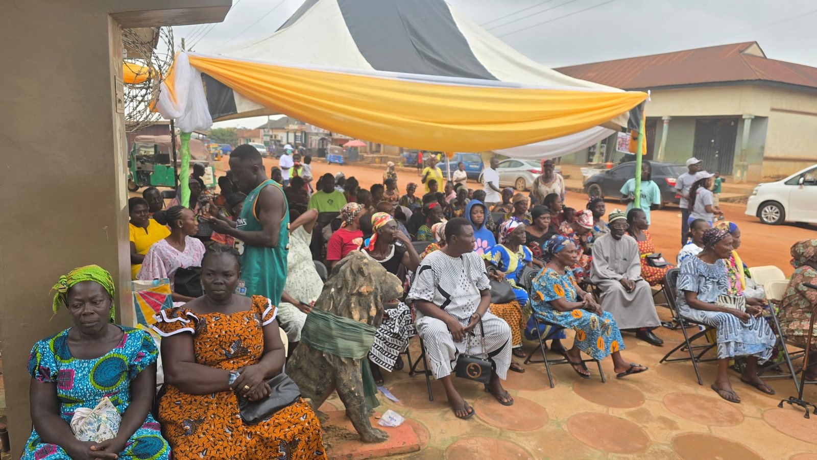 Hundreds of Abira community members seated under canopies waiting for free health screening